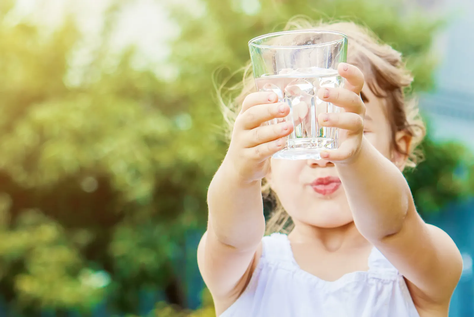 Child enjoying a glass of clean drinking water